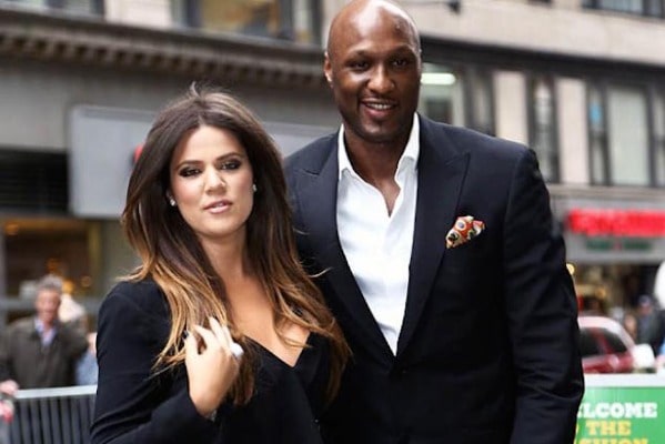 Lamar wearing black suit with white shirt .